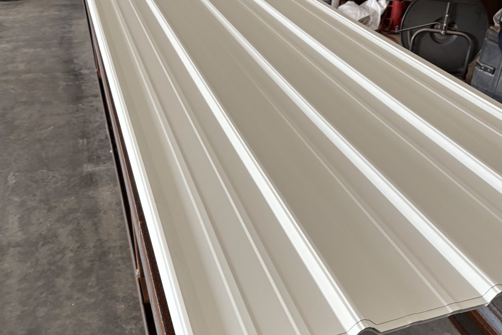 Metal roof panel coming off the forming machine in the shop